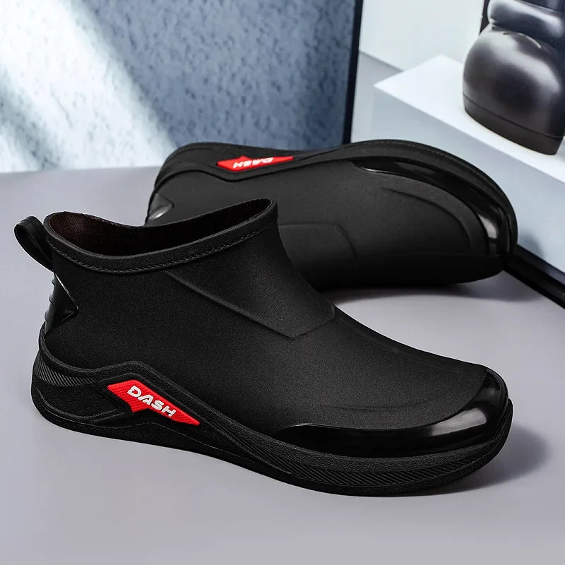 Black shoes with red logo on a gray surface
