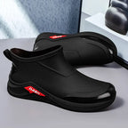 Black shoes with red logo on a gray surface