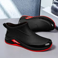 Black and red shoes on a gray surface.