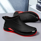 Black and red shoes on a gray surface.