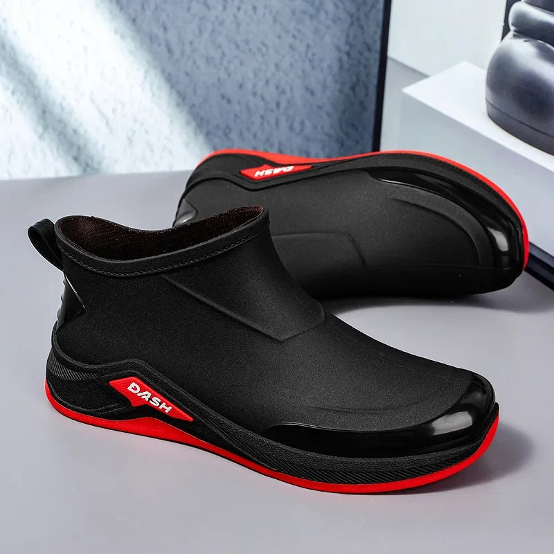 Black and red shoes on a gray surface.