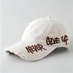 White cap with 'Never Give Up' text on a light gray background