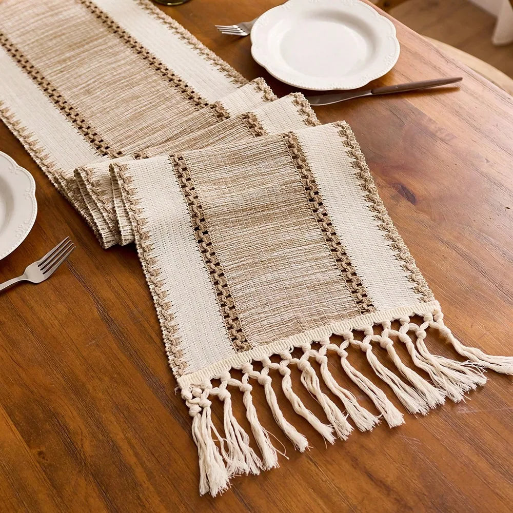 Textured table runner with tassels on a wooden table.