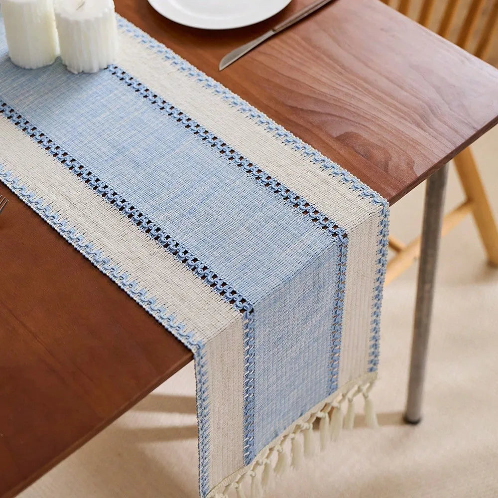 Blue and white woven table runner on a wooden table.