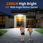 Two children at a house with a security light labeled '1300LM High Bright 180° Wide Angle Motion Sensor'.