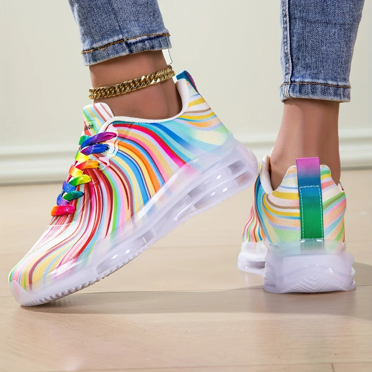 Colorful rainbow-patterned sneakers on a light wooden floor.