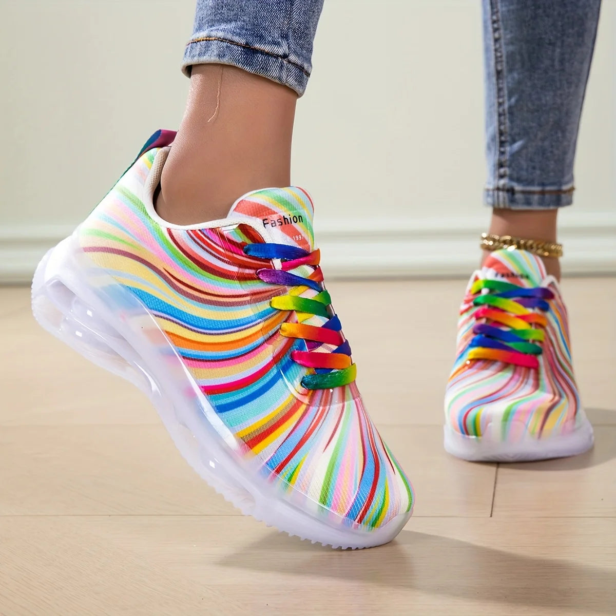 Colorful striped sneakers with rainbow laces worn indoors on a light wooden floor.