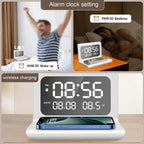 Digital alarm clock with phone charging feature, showing time and date on a wooden surface.