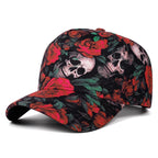 A baseball cap featuring a detailed print of red roses and human skulls on a black background, shown against a plain white studio background.