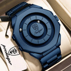 A dark blue metal watch with an integrated link bracelet and a circular dial design, shown inside a beige watch box with a branded hangtag. The brand name 'Posdagar' is visible on both the watch face and the tag.