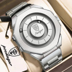 A silver-toned Polygear watch with an octagonal case and matching metal bracelet, displayed inside a beige watch box. The back of the watch is shown, featuring a circular dial design with the Polygear logo at the center.