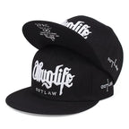 Black caps with 'Thug Life' and 'Outlaw' text on a white background.