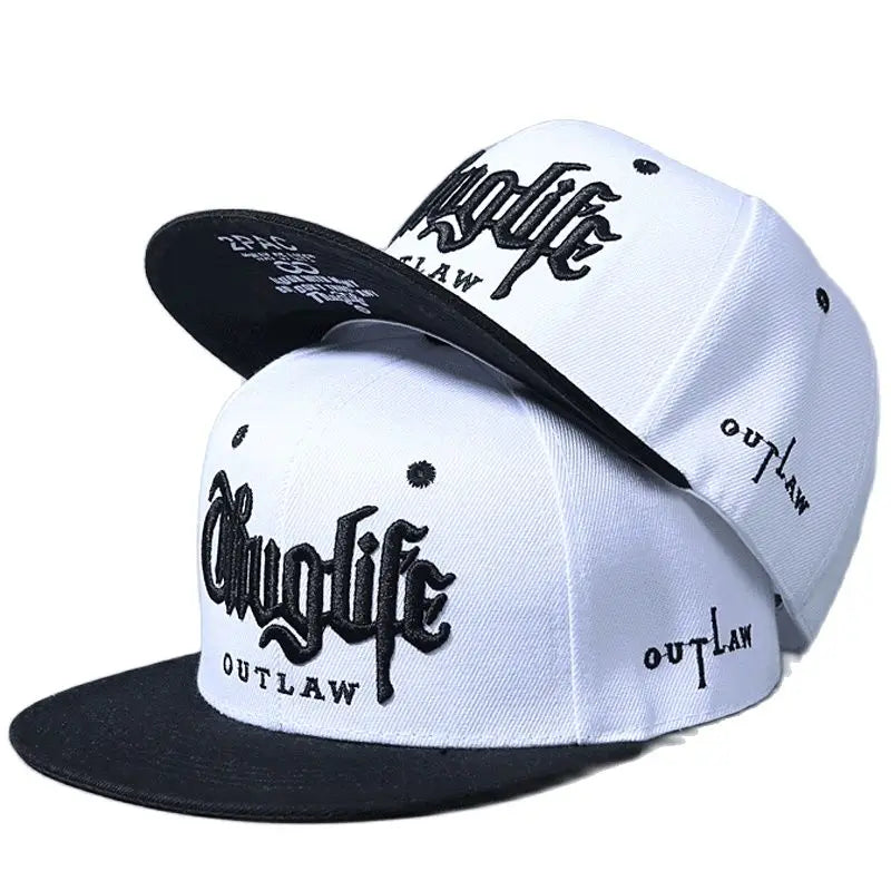 Two baseball caps with 'Outlaw' branding on a white background
