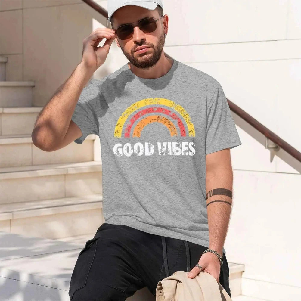 Man wearing a grey t-shirt with GOOD VIBES print.