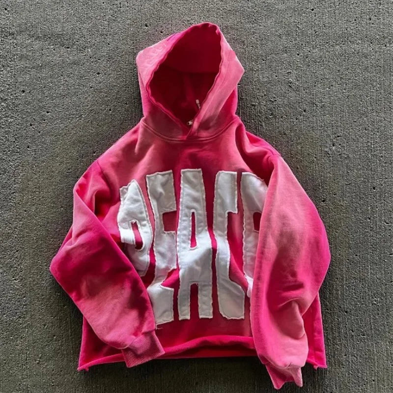 Pink streetwear vintage hoodie with white text saying PEACE.