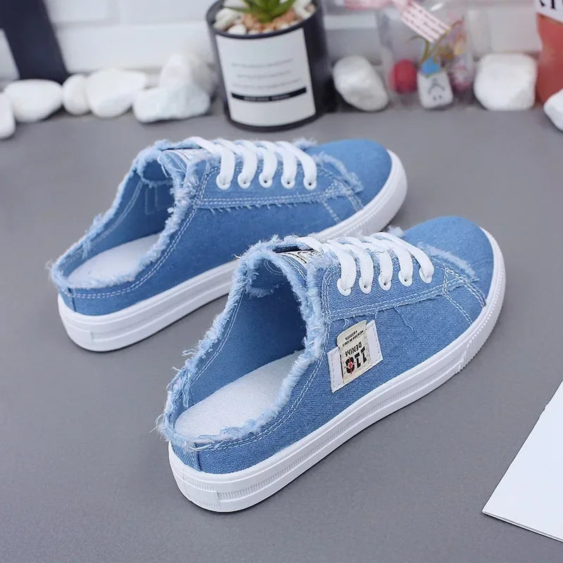 Blue denim slip on slides shoes half sneakers with white laces for women.