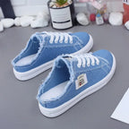 Blue denim slip on slides shoes half sneakers with white laces for women.