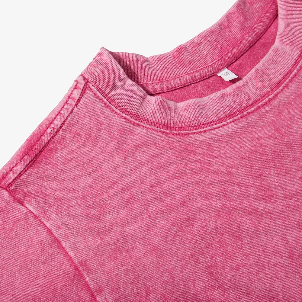 Close-up of a pink sweatshirt with a brand label on a white background