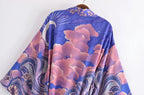 Blue and pink patterned fabric on a hanger against a white background