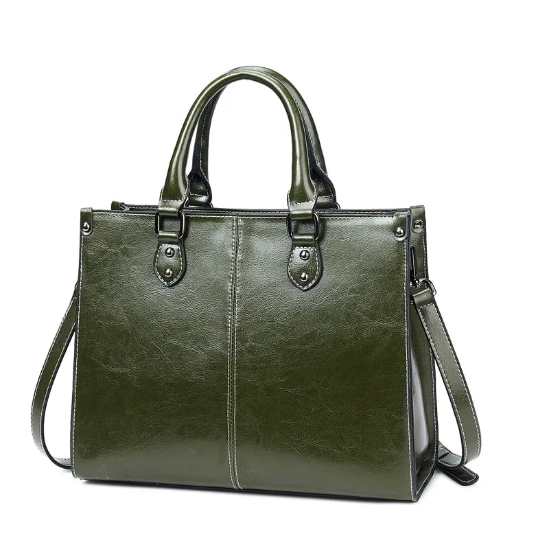Green handbag with a shoulder strap on a white background