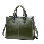 Green handbag with a shoulder strap on a white background