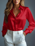 Person wearing a red satin shirt and white pants against a gray background