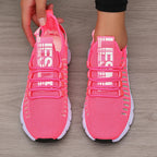Pink athletic shoes on a wooden floor