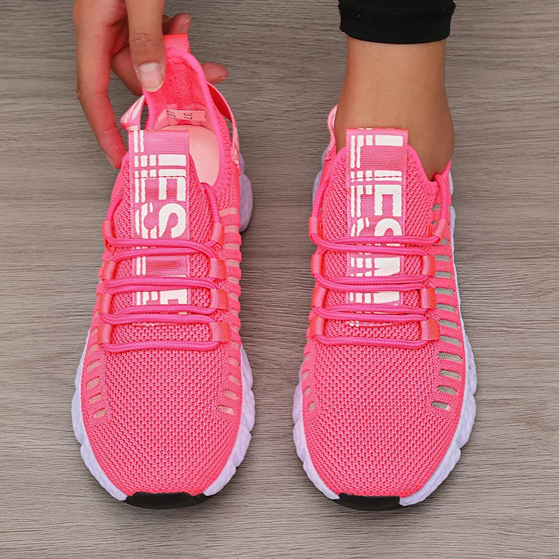 Pink athletic shoes on a wooden floor