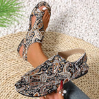 Patterned sandals worn by a person on a textured surface