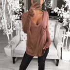 woman in a brick red long-sleeve tee stylish top long covers backside.