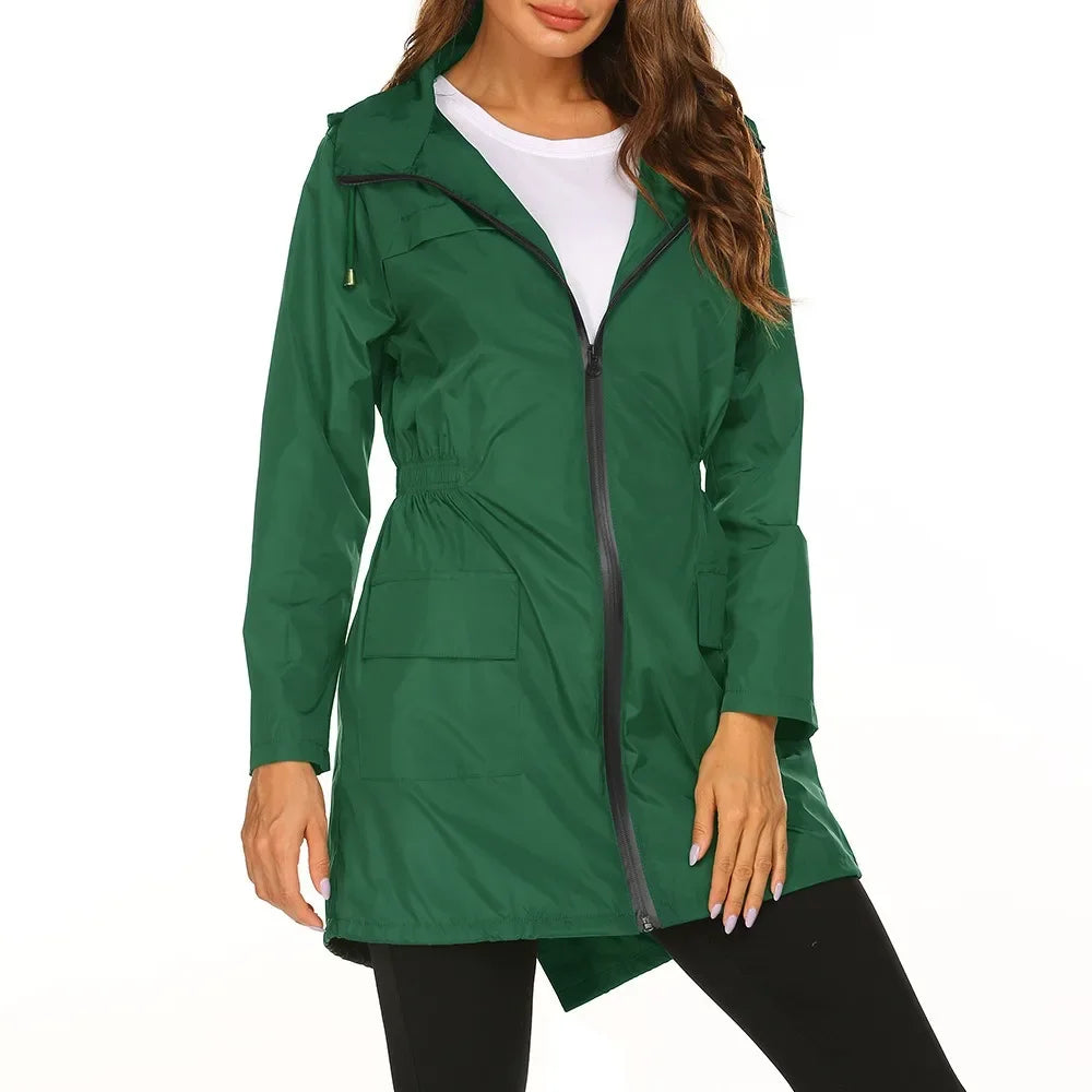 Green raincoat worn by a model on a white background
