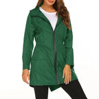 Green raincoat worn by a model on a white background
