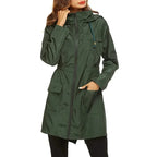 Green raincoat worn by a person on a white background