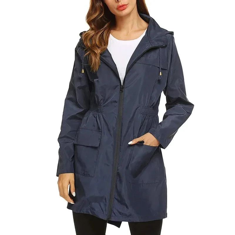 Navy blue raincoat worn by a model on a white background
