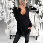 Woman in a black long-sleeve super long t-shirt casual baggy outfit.