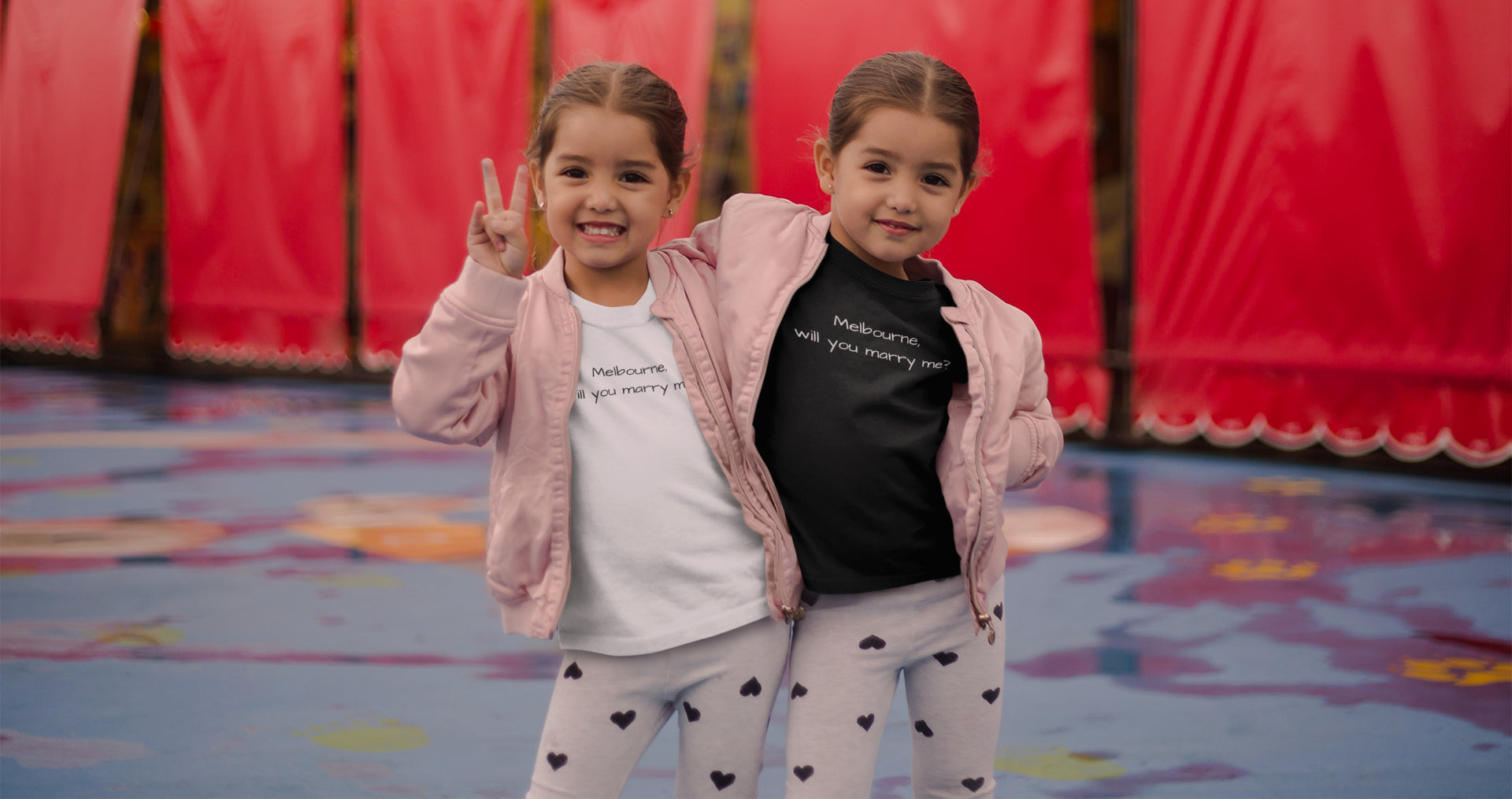 Twin girls wearing brand Keep Melbourne Marvellous clothes with slogan "Melbourne, will you marry me?"