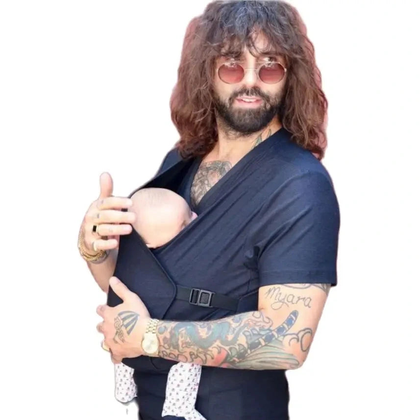 Man with a baby sling carrier against a white background.
