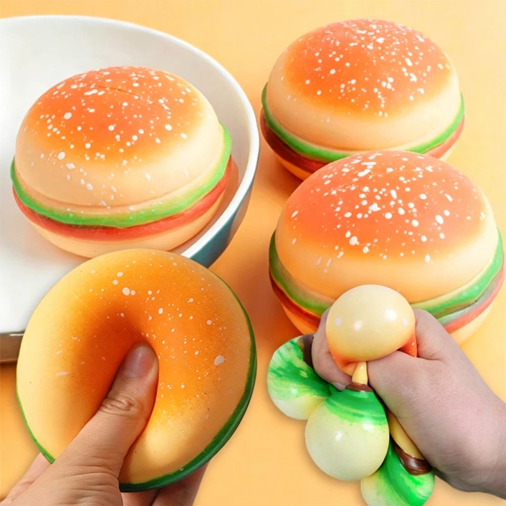 Hamburger squishy toys with two hands squeezing them to demonstrate their squishy texture.
