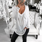 Woman wearing a white stylish oversized long-sleeve t-shirt. 